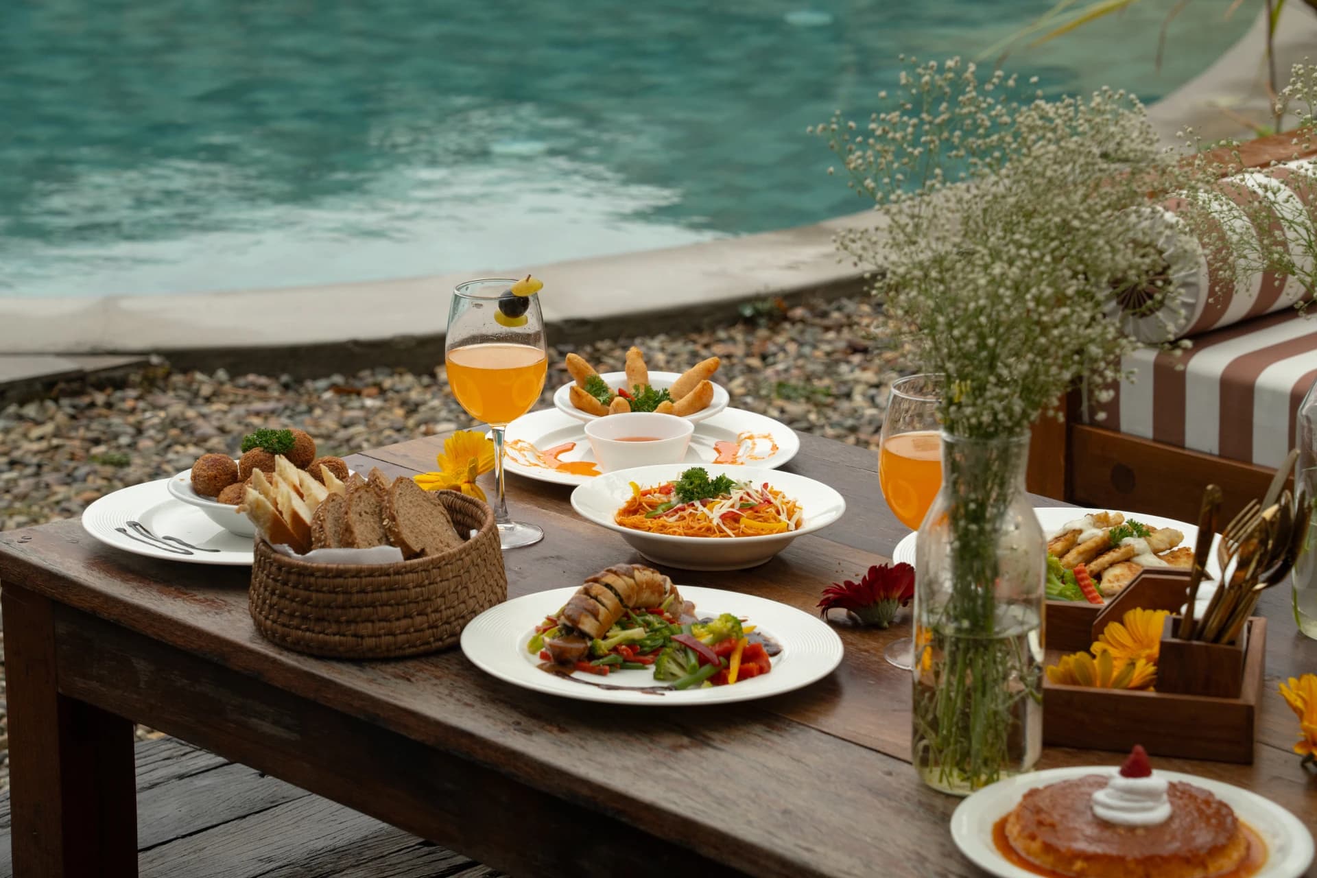Poolside dining with gourmet platters and cocktails by the pool